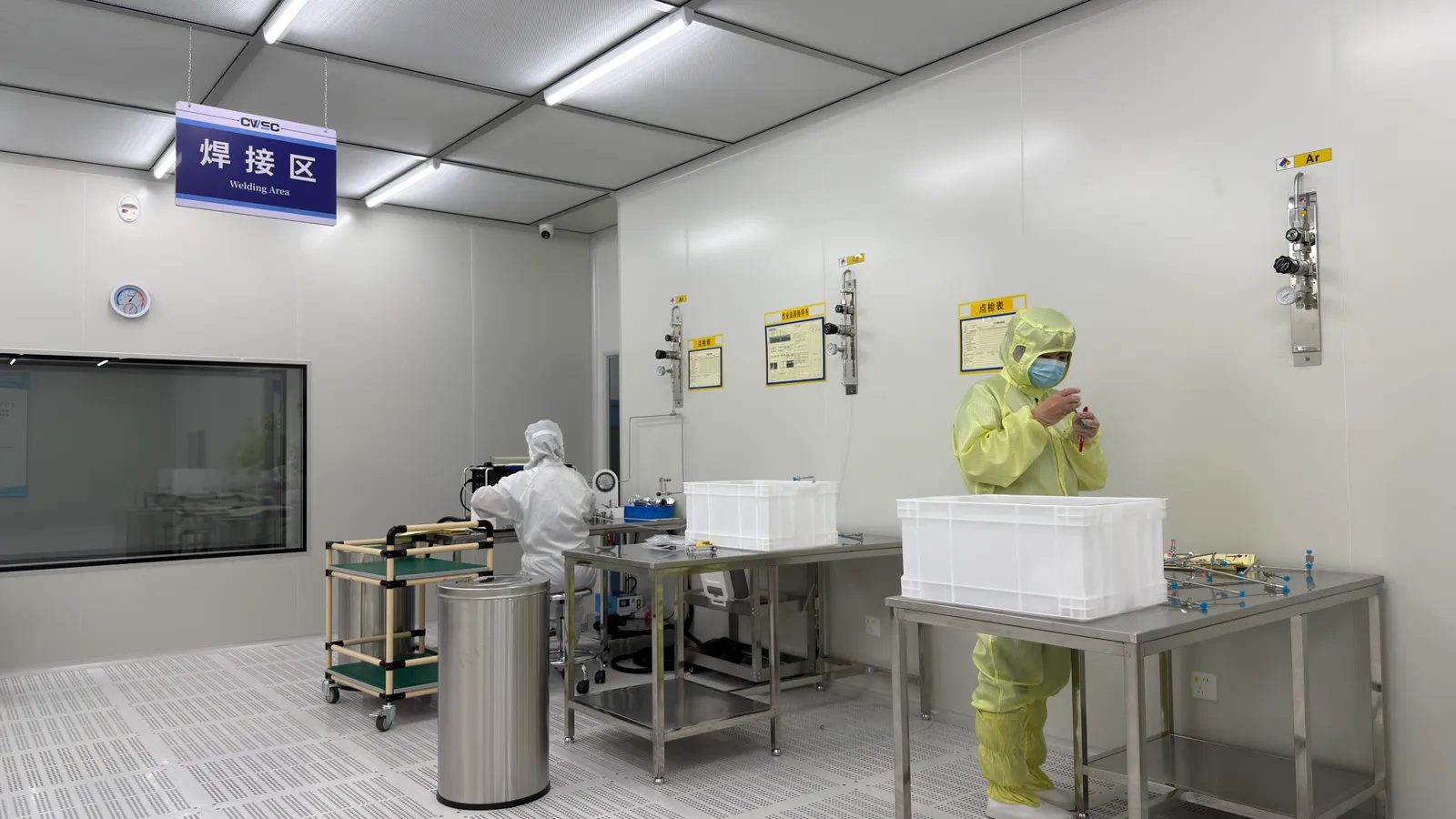 Technician in a controlled assembly workspace