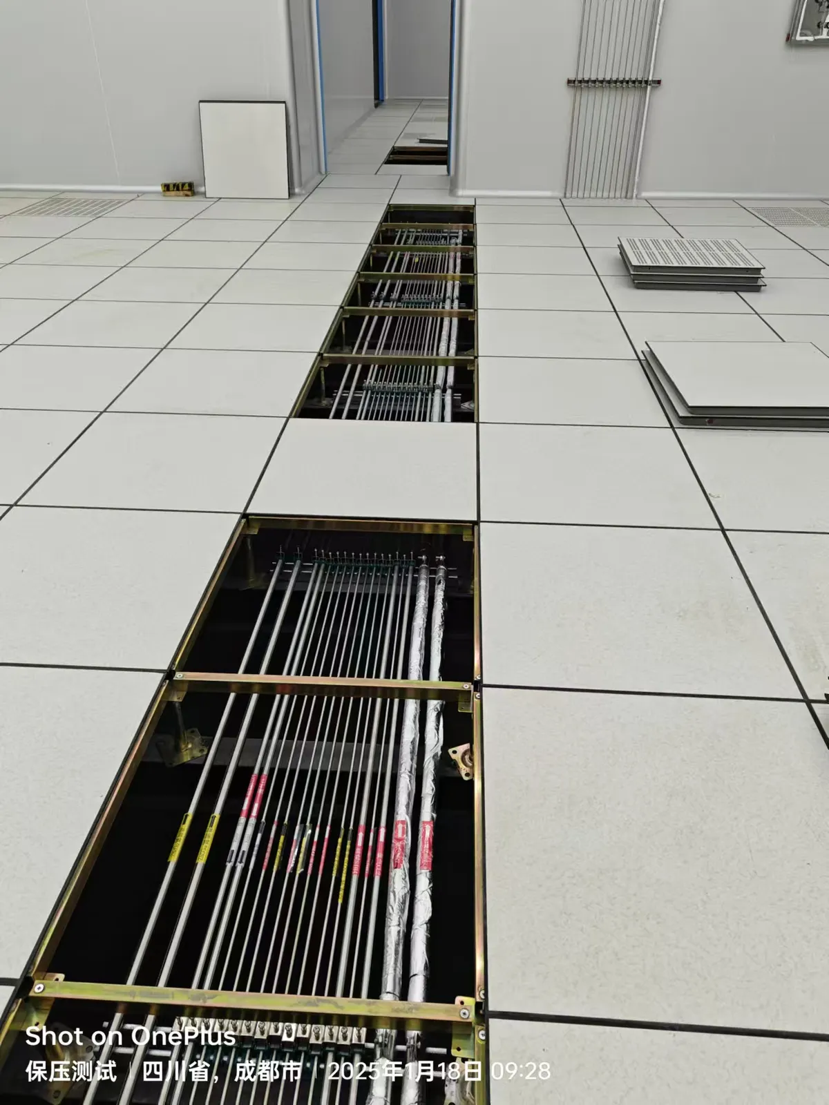 Laboratory gas lines routed through an open access-floor channel