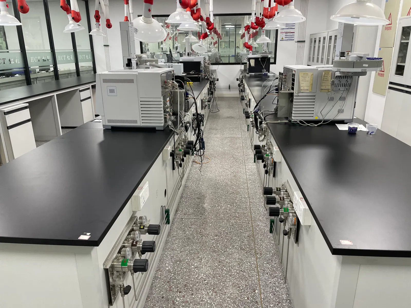 Testing laboratory bench with overhead services