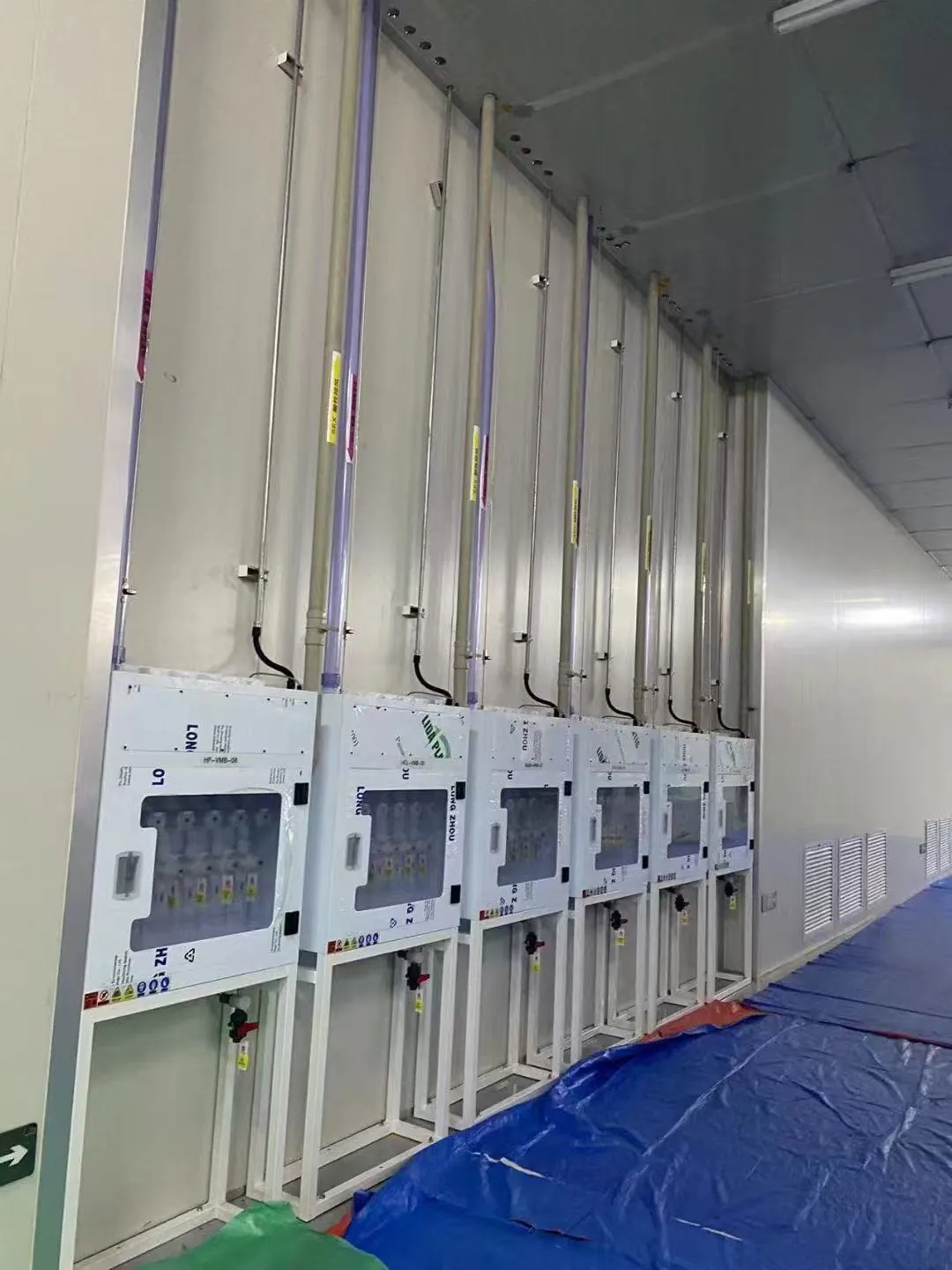 Row of gas control panels and connected pipework